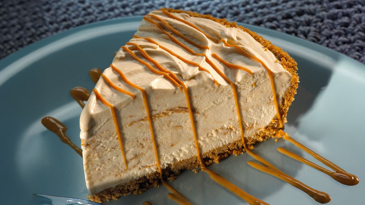 slice of peanut butter ice cream pie drizzled with peanut butter topping